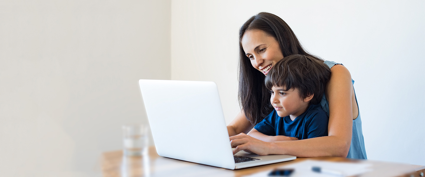 parent with child and laptop